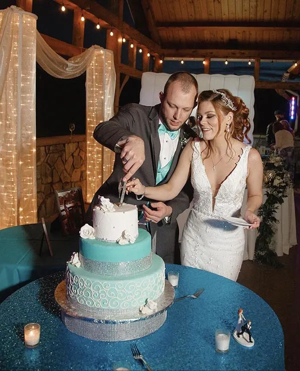 A bride and groom cutting their wedding cake at Creek's Edge Winery.