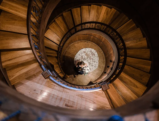 A bride and groom in the spiral staircase at Creek's Edge Winery.