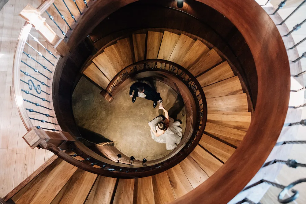 A wedding photo in the spiral staircase at Creek's Edge Winery.