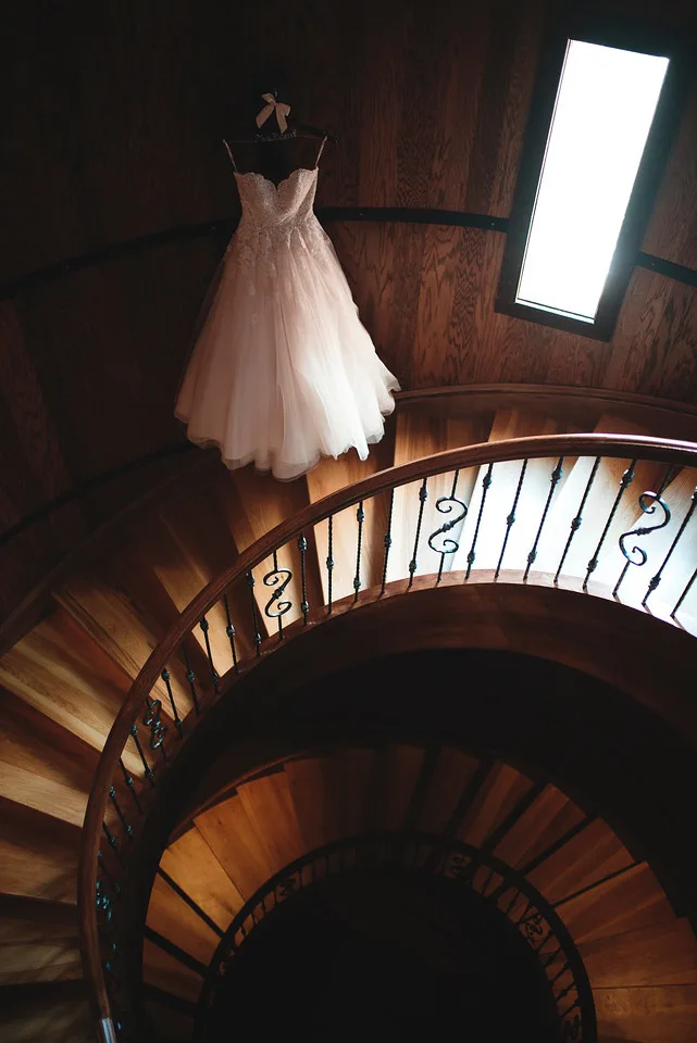 A wedding dress hung up in the spiral staircase at Creek's Edge Winery.
